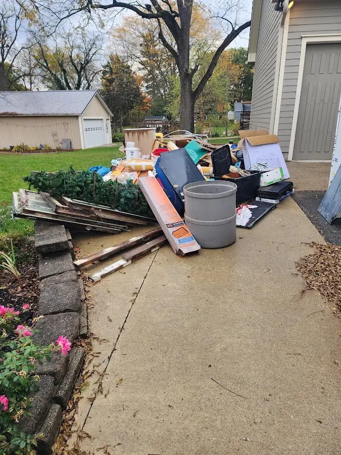 Dumpster being loaded with debris for 12 Yard Dumpster Rental in Clyde